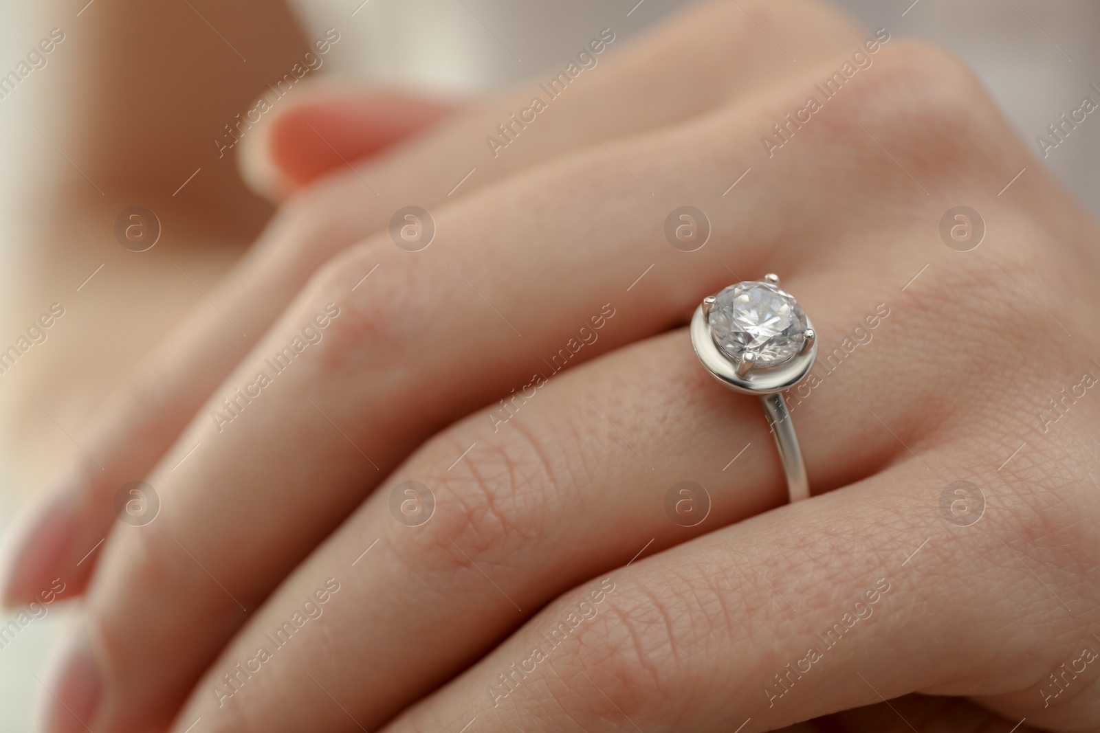 Photo of Young bride wearing beautiful engagement ring, closeup