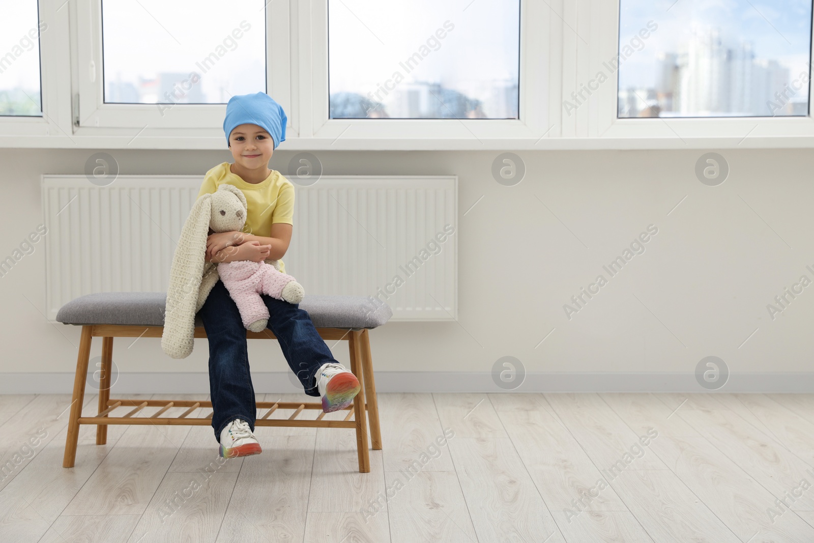 Photo of Childhood cancer. Girl with toy bunny in hospital