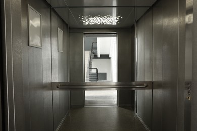 Photo of Open elevator`s cabin with big mirror indoors