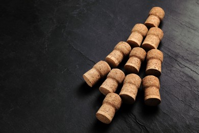 Christmas tree made of wine corks on dark stone background. Space for text
