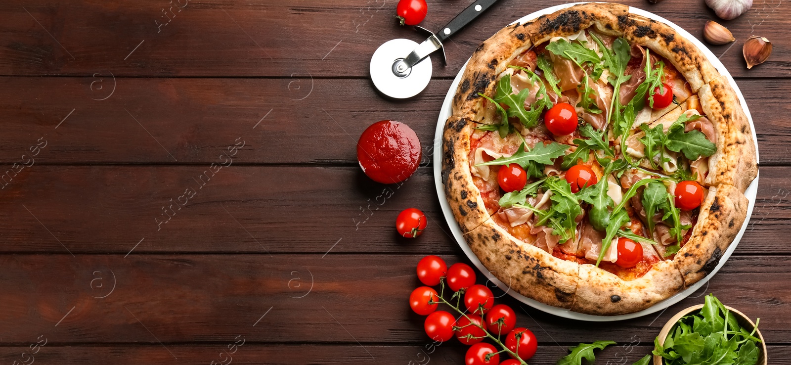 Photo of Tasty pizza with meat and arugula on wooden table, flat lay. Space for text