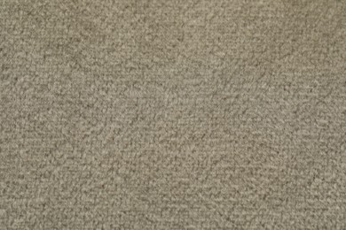 Photo of Texture of soft beige fabric as background, top view