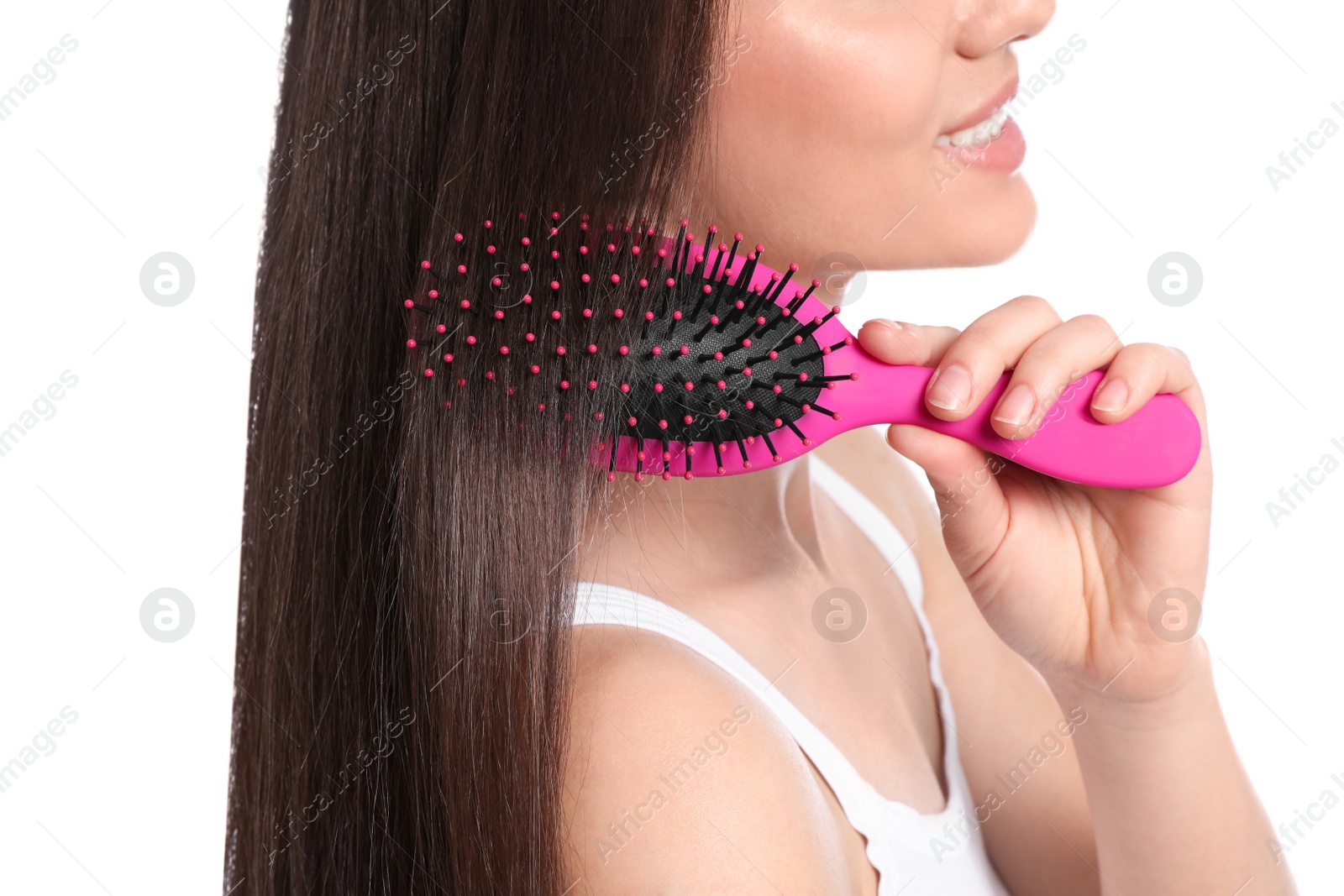 Photo of Woman with hair brush on white background, closeup