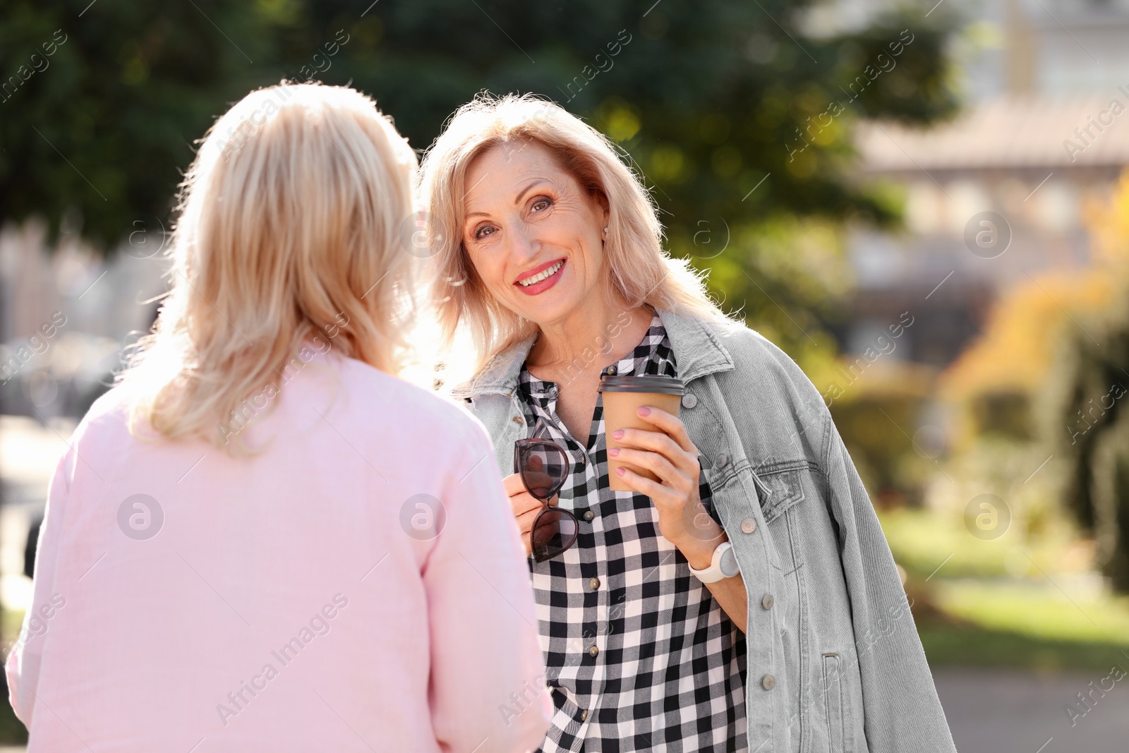 Photo of Happy mature women in park on sunny day