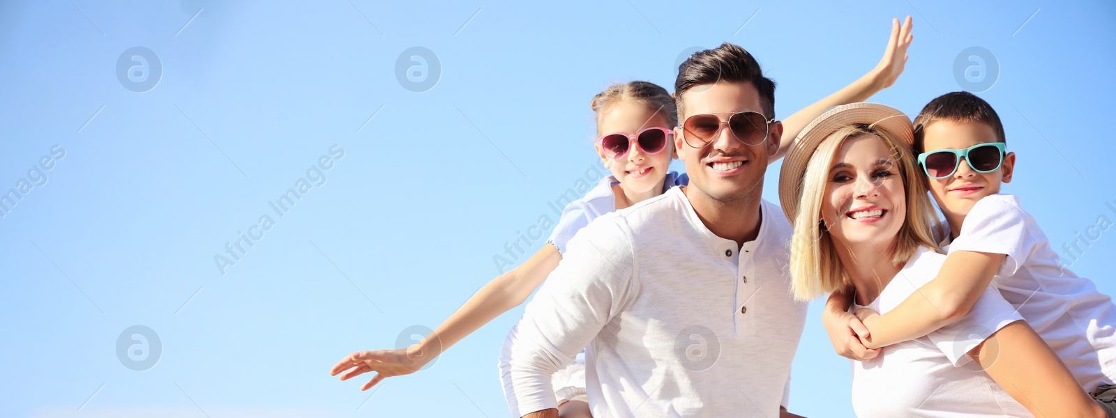 Image of Happy family outdoors on sunny summer day, space for text. Banner design