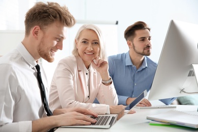 Photo of Business people working at table. Professional communication