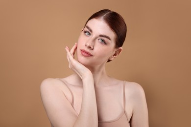 Portrait of beautiful woman on beige background