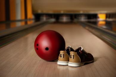Photo of Shoes and ball on alley in bowling club