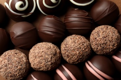 Photo of Many different delicious chocolate truffles, top view