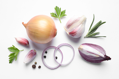 Flat lay composition with cut onion and spices on white background