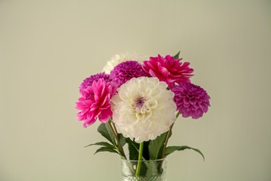 Photo of Bouquet of beautiful Dahlia flowers near white wall