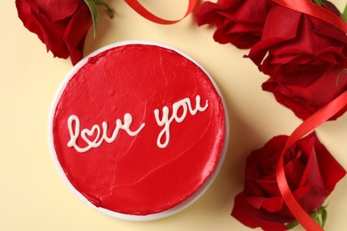 Bento cake with text Love You and red roses on beige table, top view. St. Valentine's day surprise