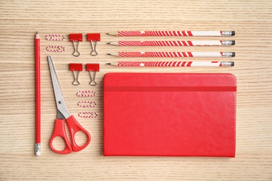 Different school stationery on wooden background, flat lay