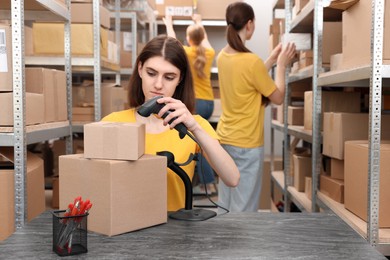 Young post office employees working in warehouse