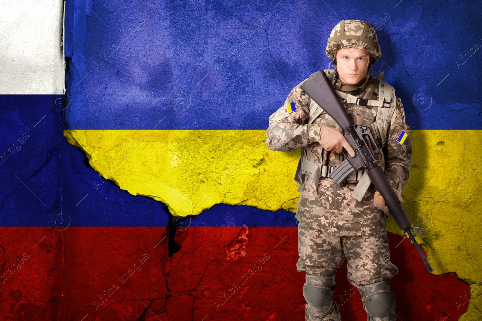 Image of Armed Ukrainian soldier against national flag of Ukraine. Russian-Ukrainian war, 2022