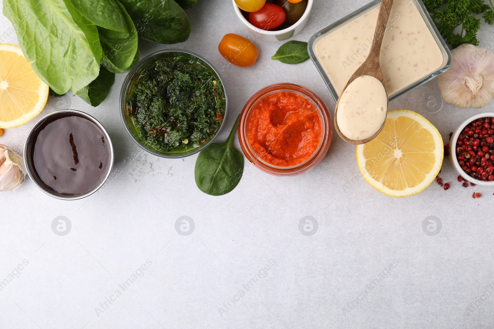 Photo of Different marinades and products on light table, flat lay. Space for text