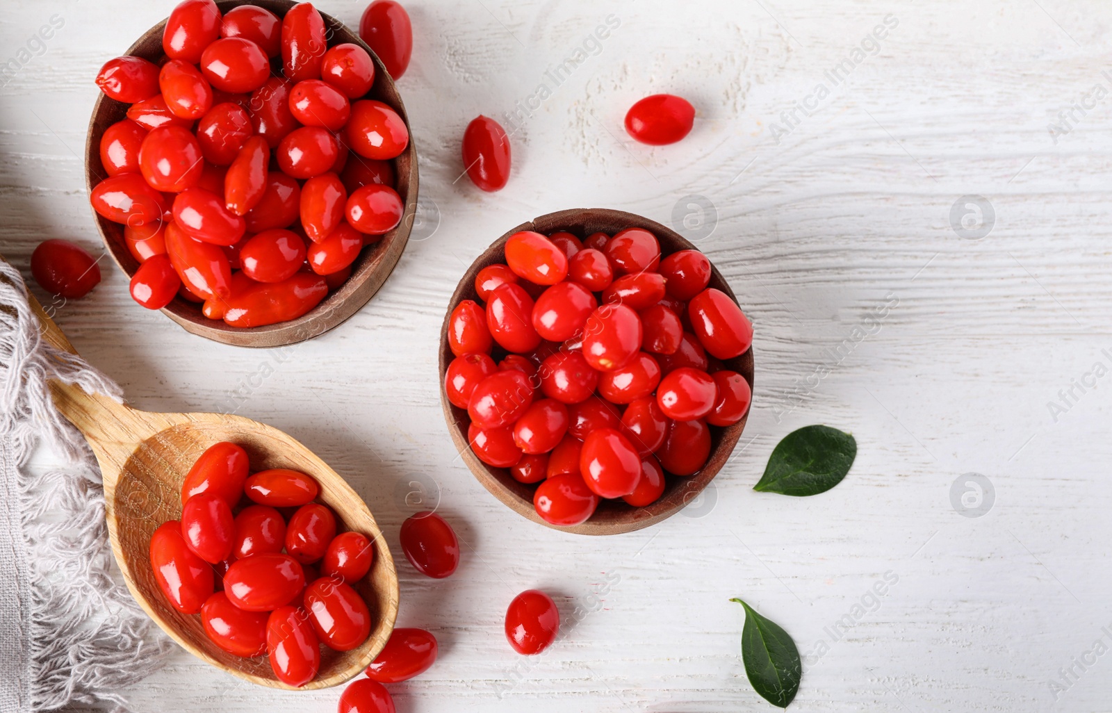 Photo of Flat lay composition with fresh ripe goji berries on white wooden table