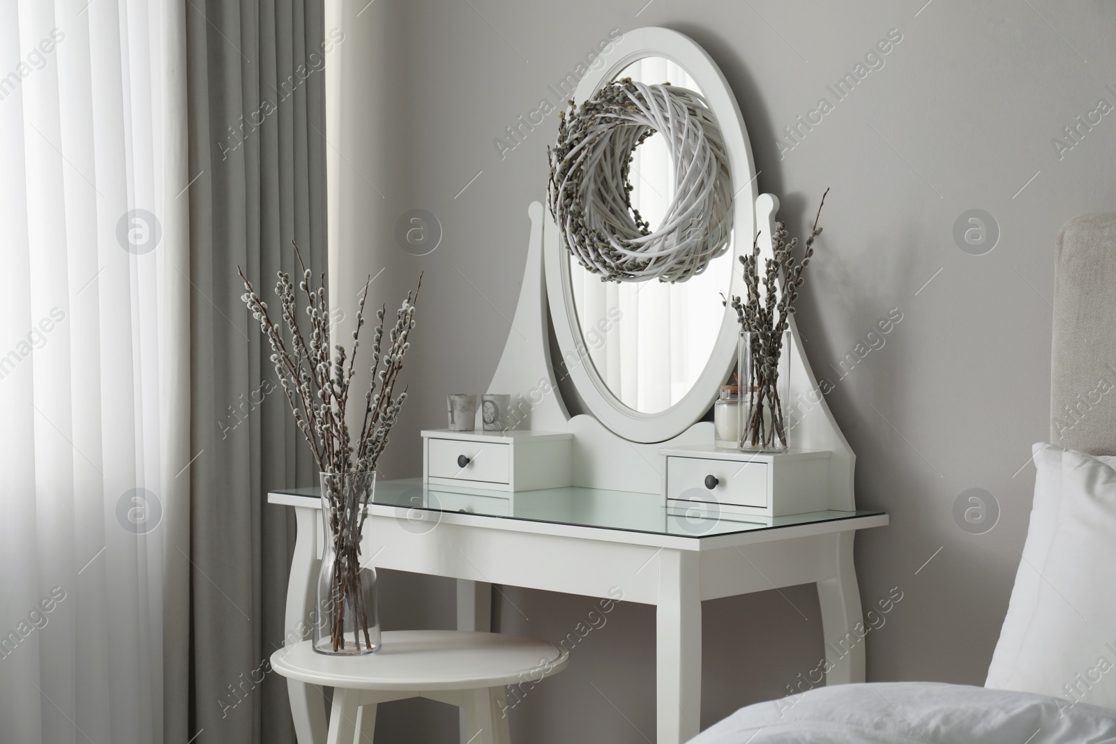 Photo of Elegant dressing table decorated with pussy willow branches indoors