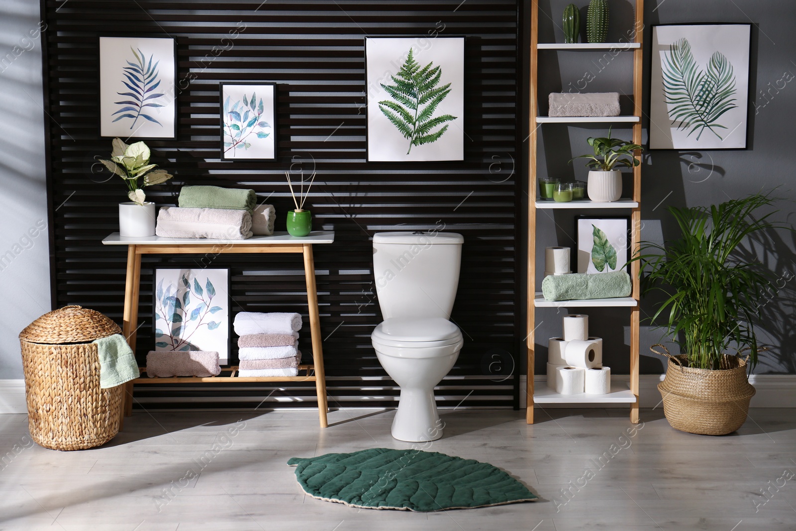 Photo of Stylish bathroom interior with toilet bowl and other essentials