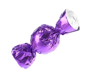 Photo of Tasty candy in purple wrapper isolated on white