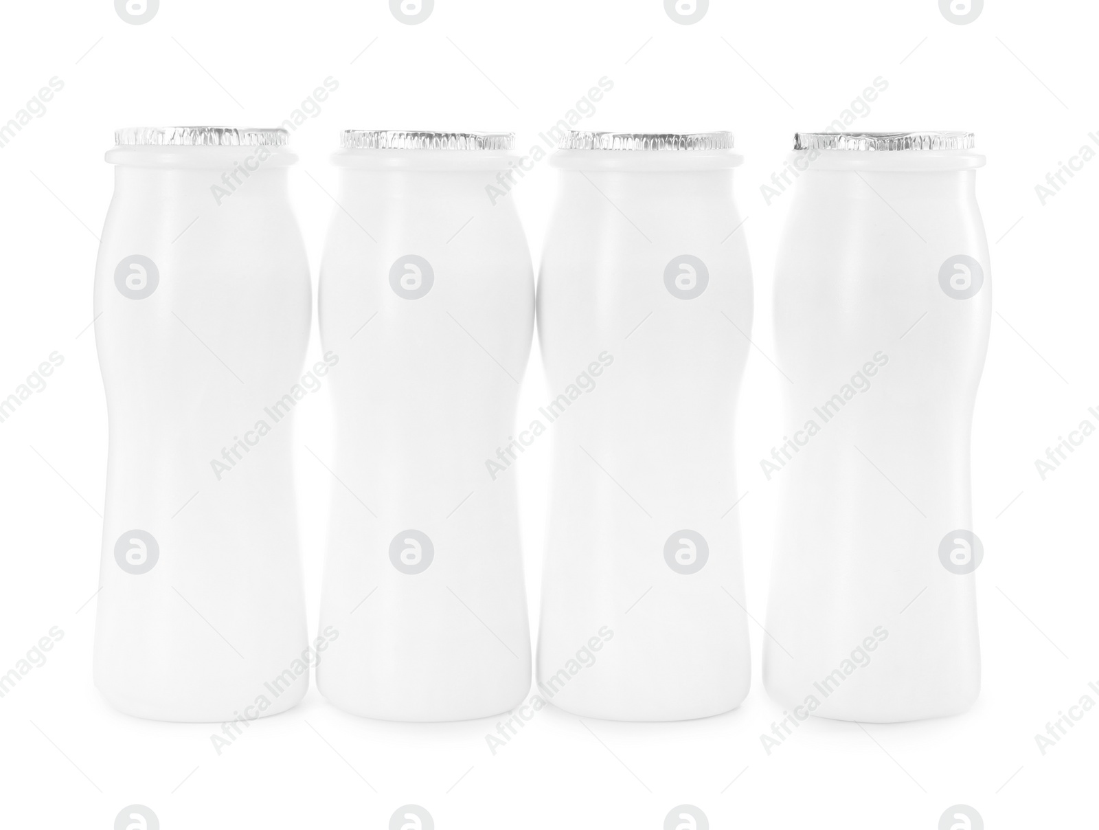 Photo of Tasty yogurt in bottles isolated on white