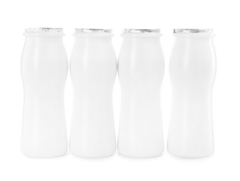 Photo of Tasty yogurt in bottles isolated on white