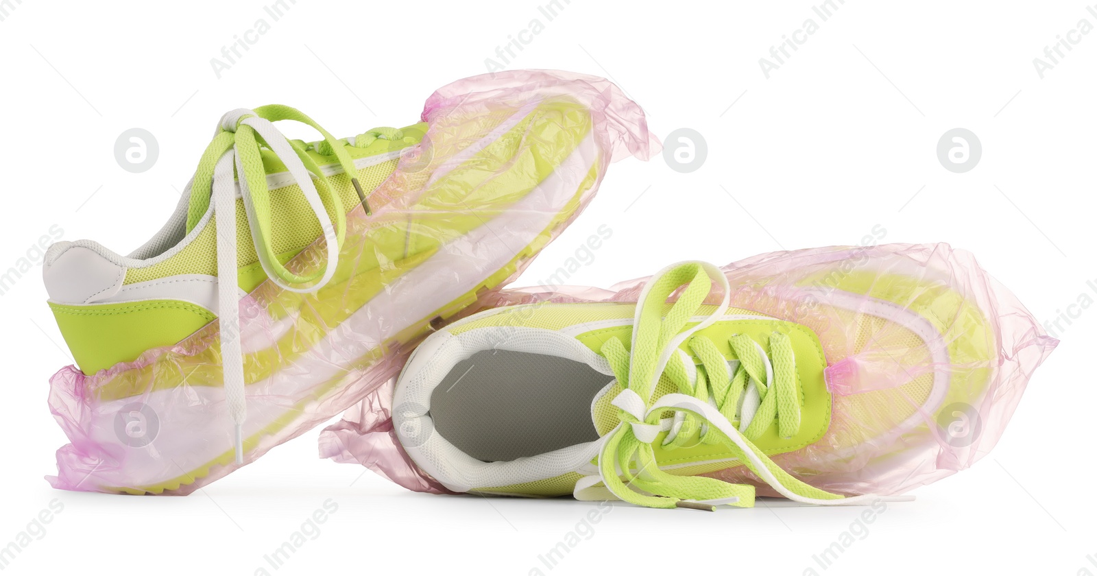 Photo of Sneakers in pink shoe covers isolated on white