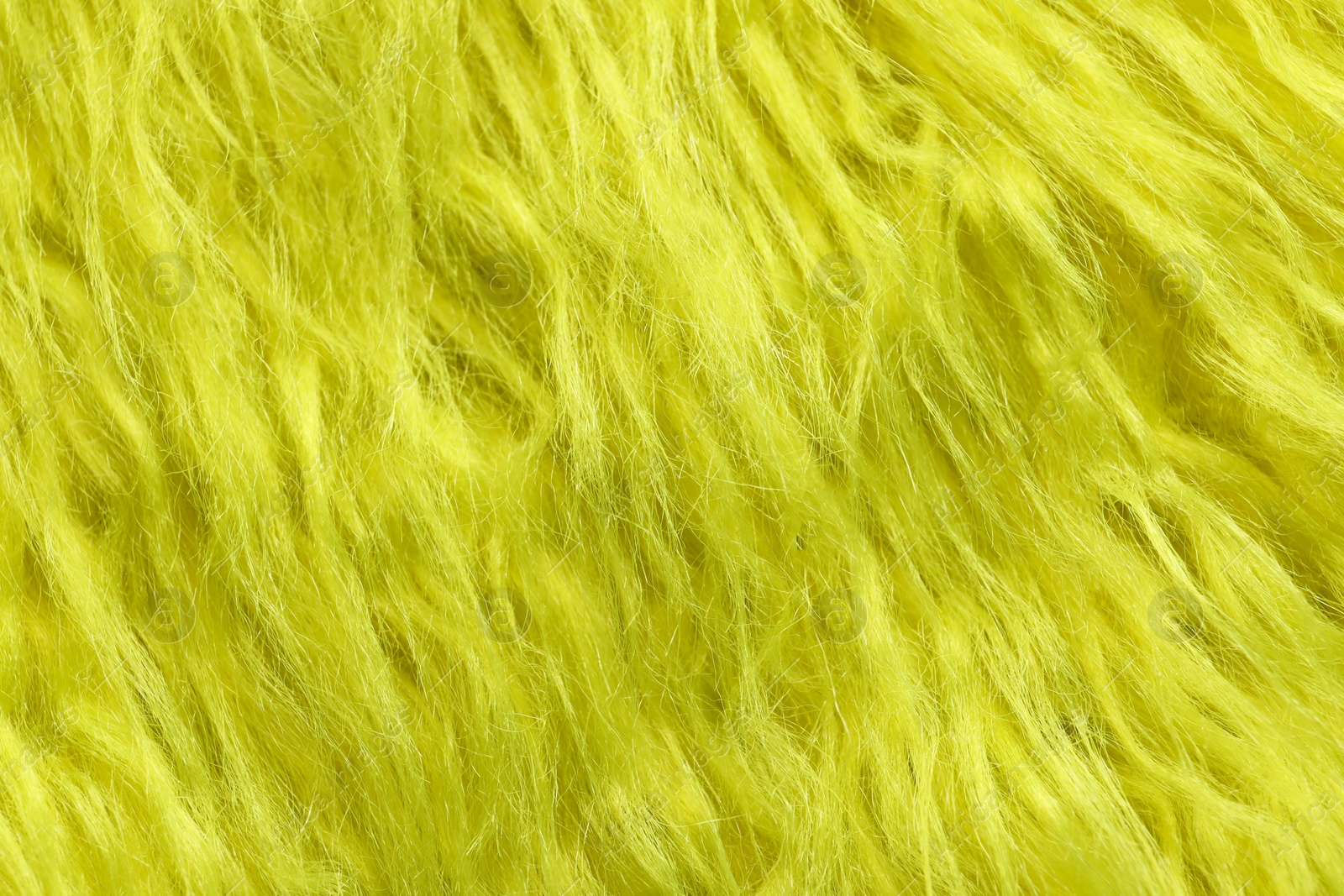 Photo of Texture of yellow faux fur as background, closeup