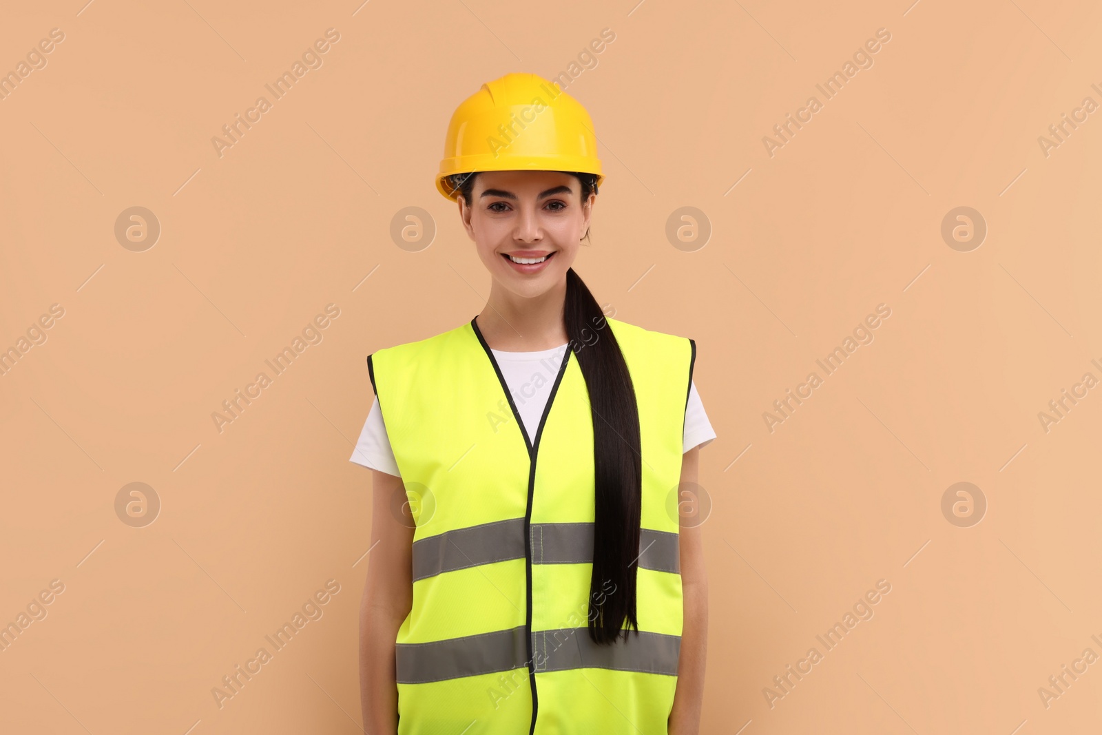 Photo of Engineer in hard hat on beige background