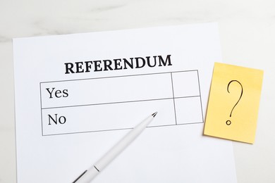 Photo of Referendum ballot, pen and sticky note with question mark on white marble table, flat lay