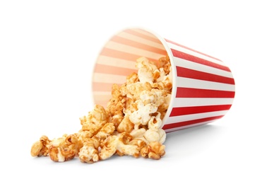 Overturned cup with delicious fresh popcorn on white background