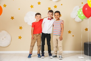 Adorable little boys at birthday party indoors