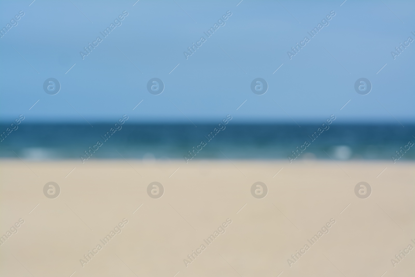 Photo of Blurred view of sandy beach and blue sea