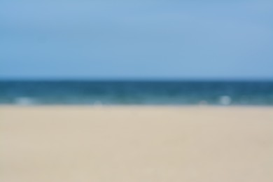 Blurred view of sandy beach and blue sea