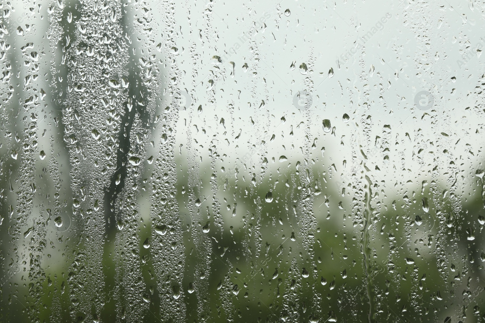 Photo of Window glass with raindrops as background, closeup