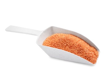 Photo of Orange salt in scoop isolated on white