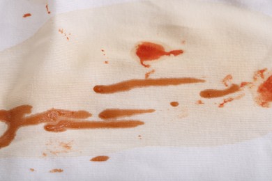 Photo of White shirt with stain of sauce as background, closeup
