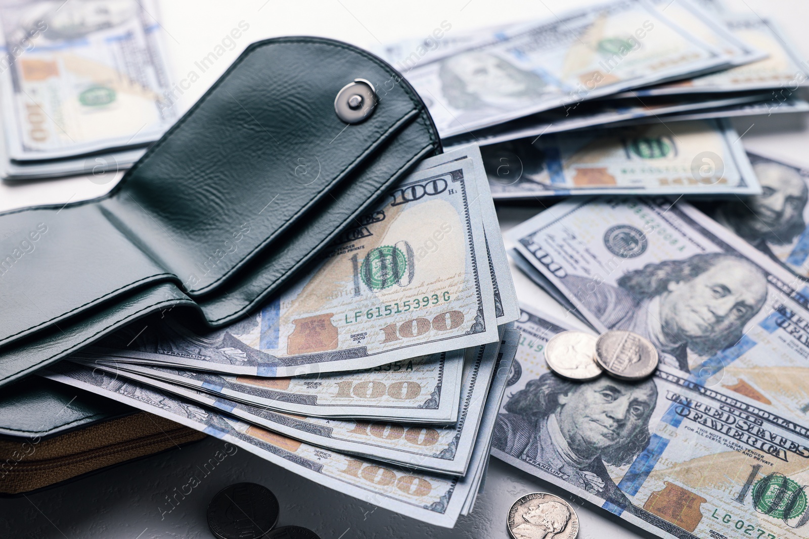 Photo of Dollar banknotes, coins and wallet on white table, closeup. Money exchange