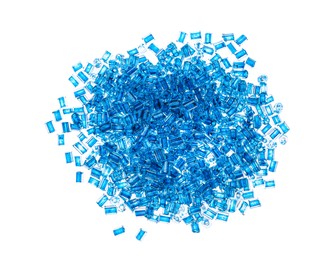 Pile of light blue beads on white background, top view