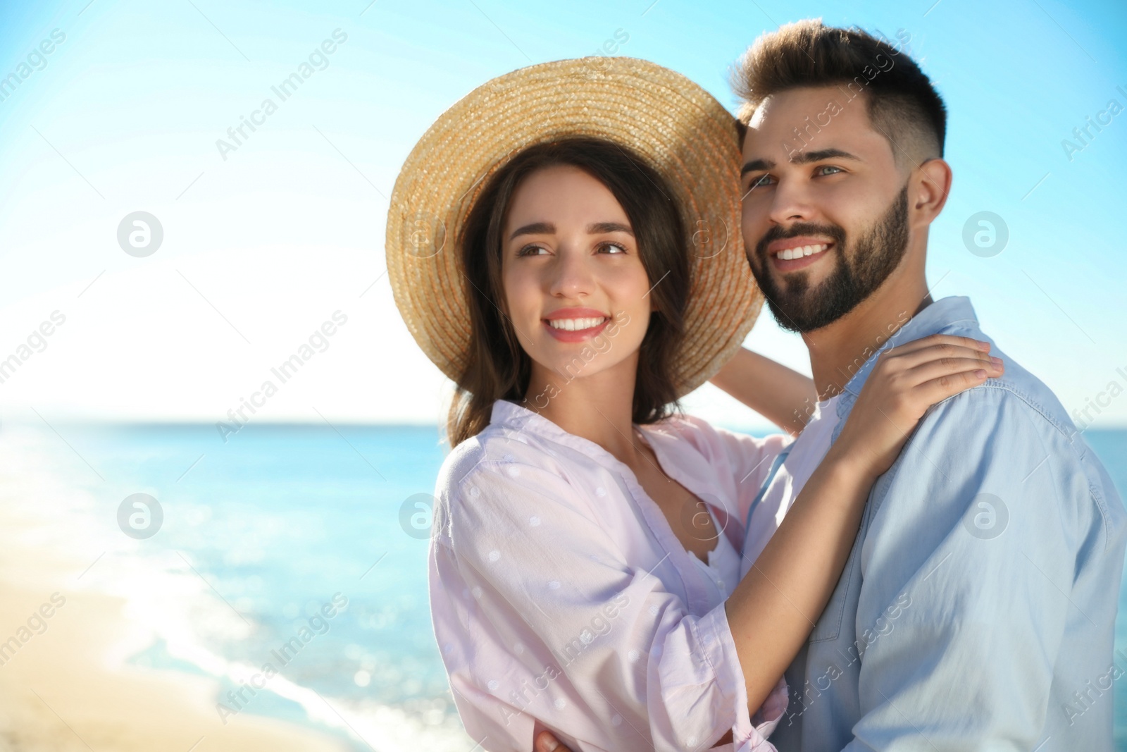 Photo of Happy young couple at beach. Honeymoon trip