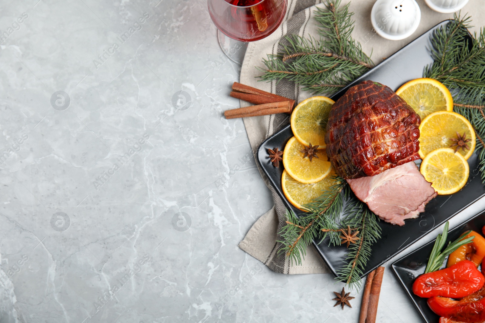 Photo of Festive flat lay composition with delicious ham on grey marble table, space for text. Christmas dinner