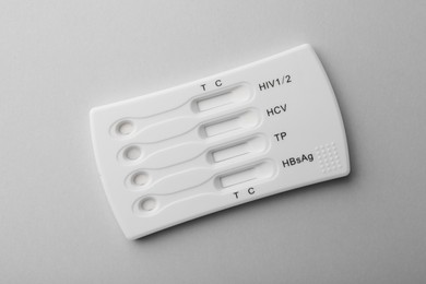 Disposable multi-infection express test on light grey background, top view