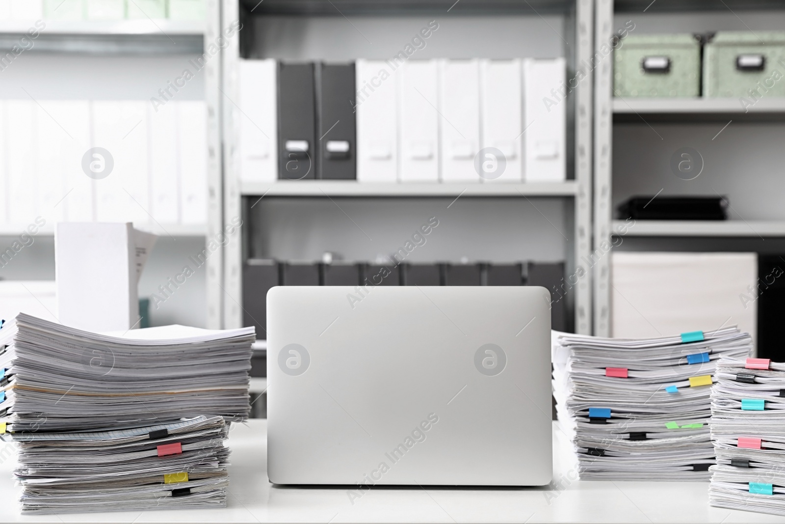 Photo of Laptop and documents on desk in office