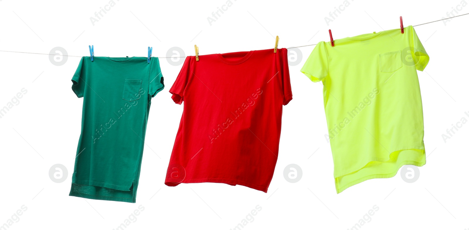 Photo of Colorful t-shirts drying on washing line isolated on white