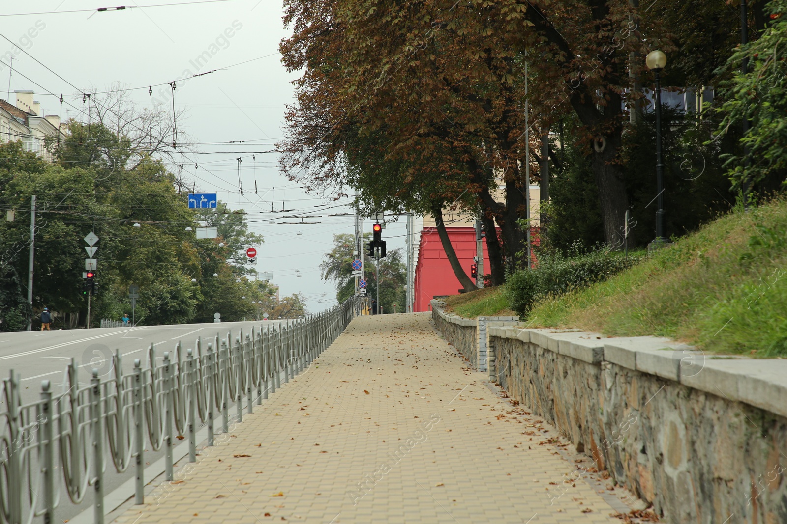 Photo of Picturesque view of quiet street with beautiful sidewalk and trees