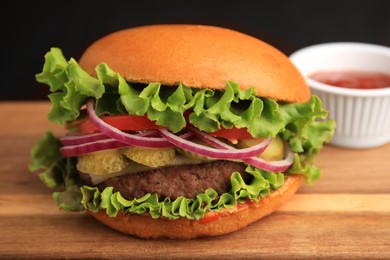 One tasty burger with on wooden table, closeup