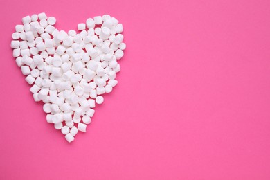 Photo of Heart made of delicious marshmallows on pink background, flat lay. Space for text