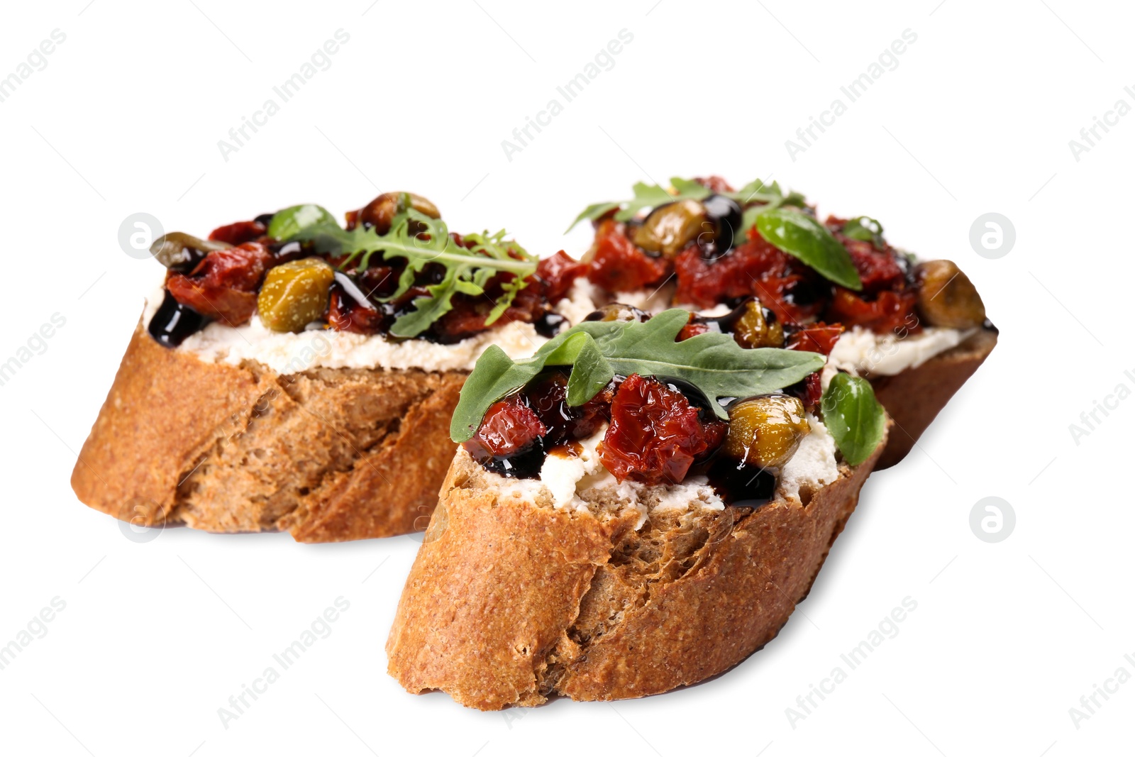 Photo of Delicious bruschettas with balsamic vinegar and toppings isolated on white