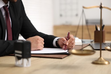 Photo of Lawyer working at table in office, selective focus
