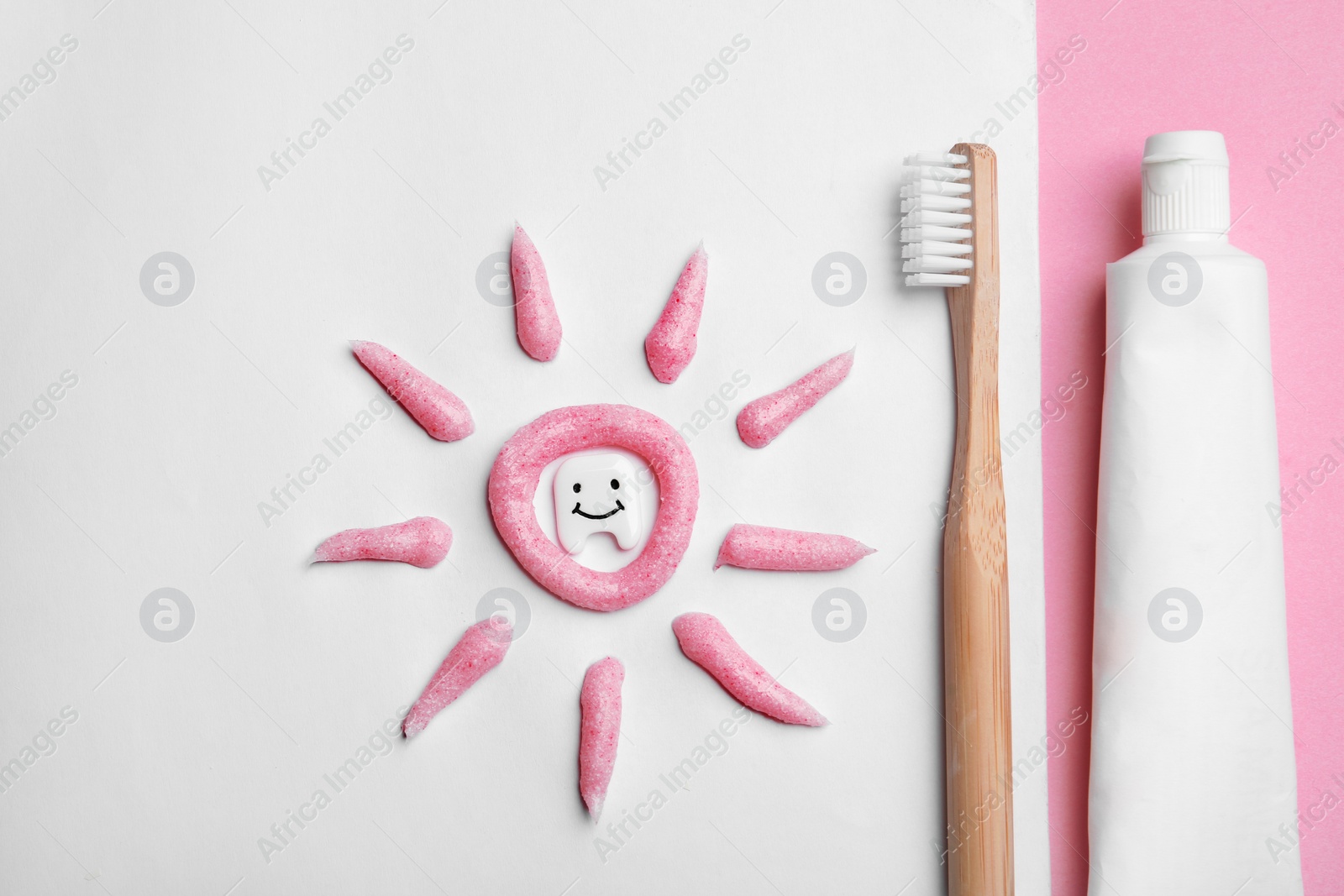 Photo of Flat lay composition small plastic tooth and oral care products on color background